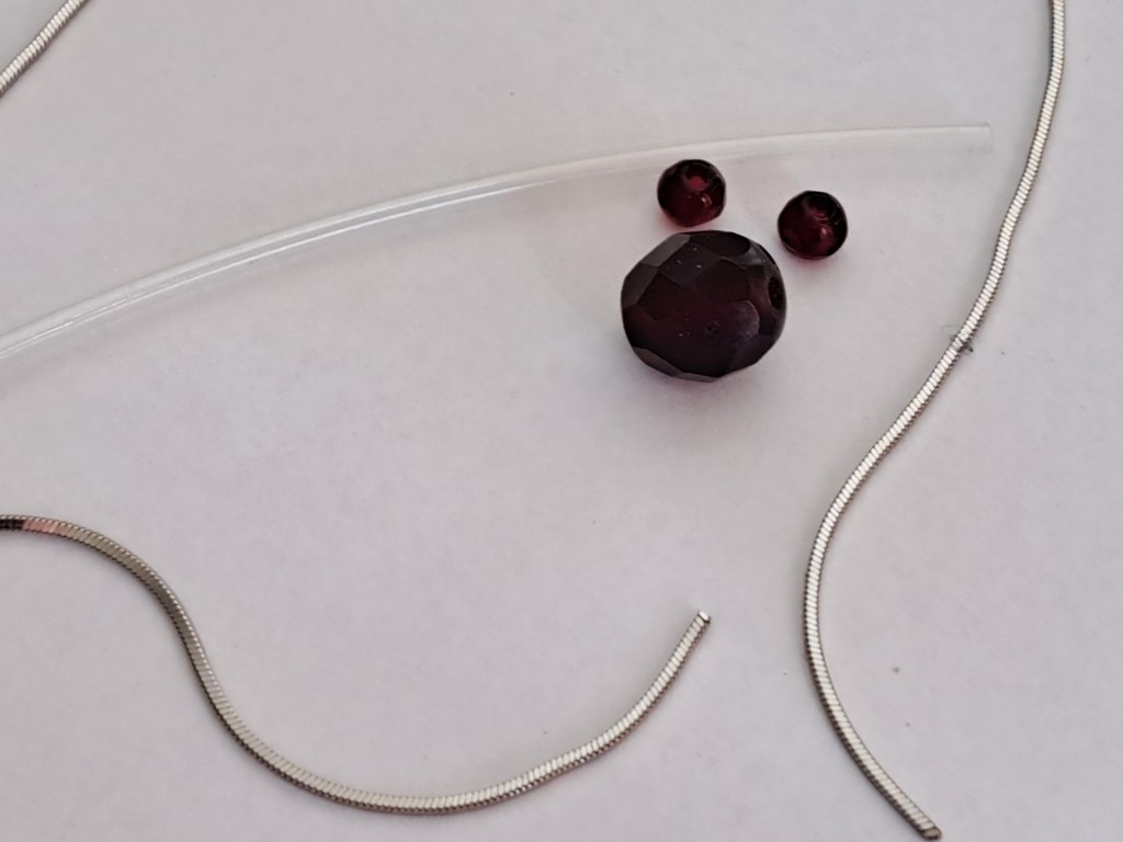 Silver and garnet beads. All material is reused.